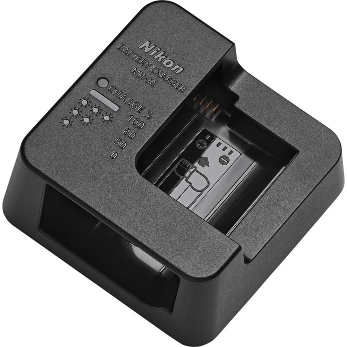 Schwarzes Nikon MH-34 Akkuladegerät in einer schrägen Ansicht von oben, mit einer Ladeschale für Kameraakkus, aufgedruckten Prozentanzeigen für den Ladestatus (0, 50, 80, 100), einer LED-Statusleuchte sowie dem eingeprägten Nikon-Logo, freigestellt vor we